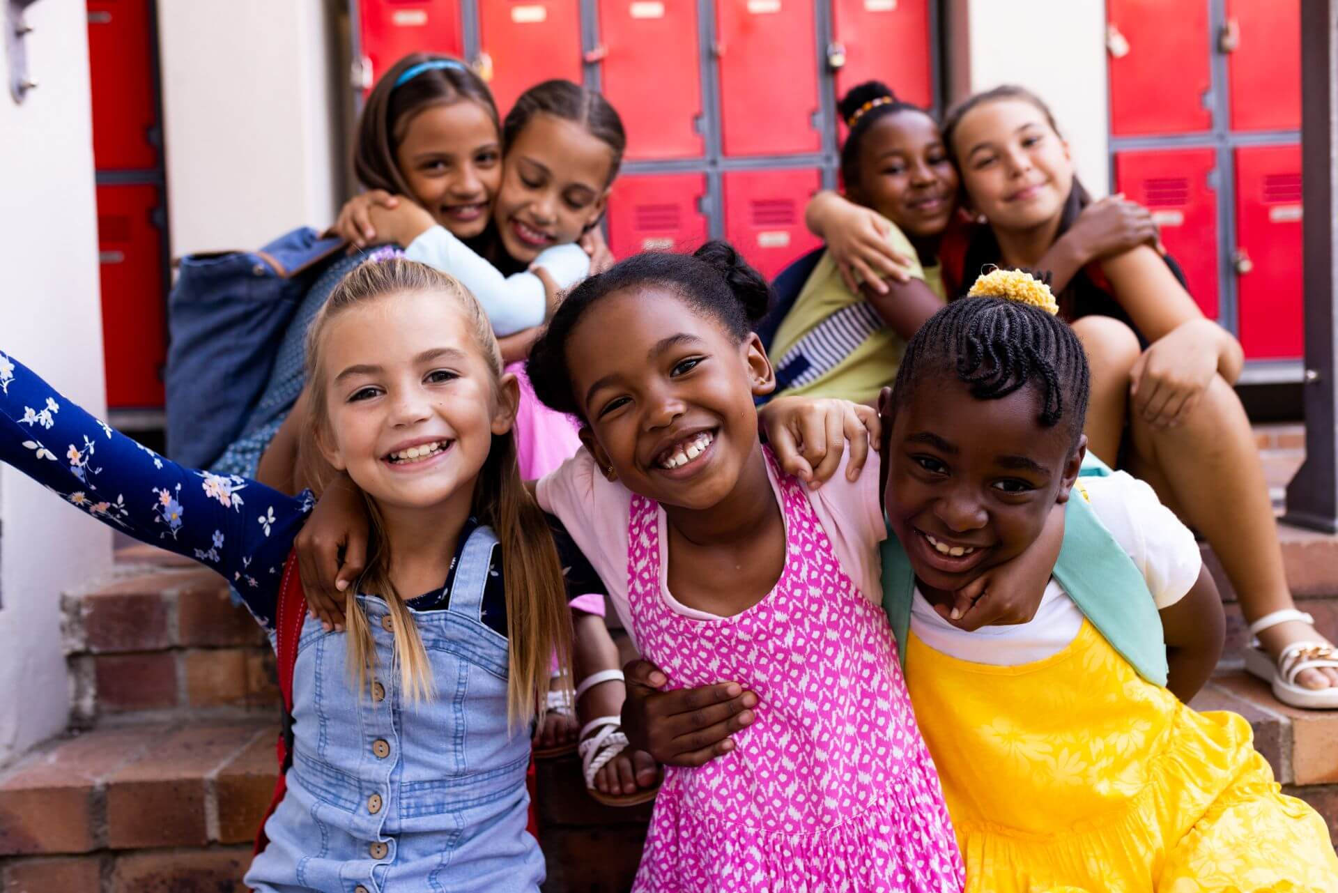 Happy schoolgirls embracing